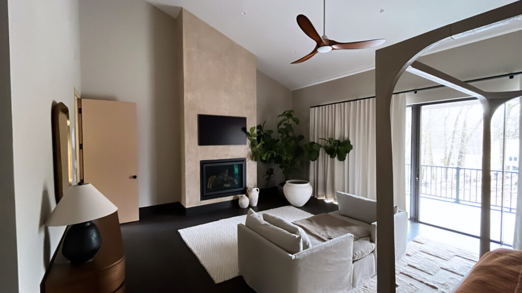 Interior painting project in Stamford CT with soft neutral walls and warm bedroom atmosphere
